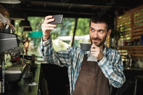 Wallpaper Mural Portrait of caucasian barista man taking selfie photo while working in street cafe or coffeehouse outdoor Torontodigital.ca