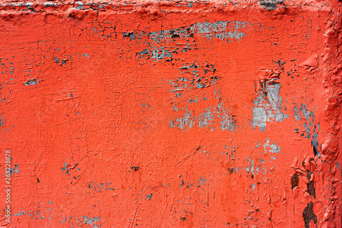Old colored cracked wall. Grunge red and green wall texture for design. Old paint texture is chipping and cracked fall destruction. Abstract background of old red painted wall.