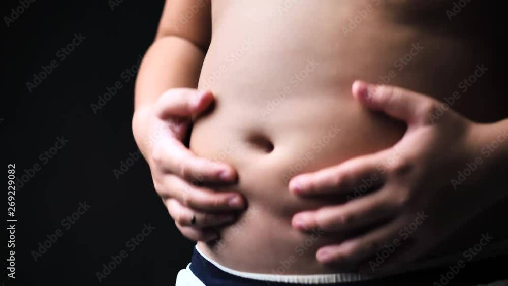 Fat preteen boy move and shake his tummy, slow motion. Fat preteen boy move and shake his tummy, slow motion.