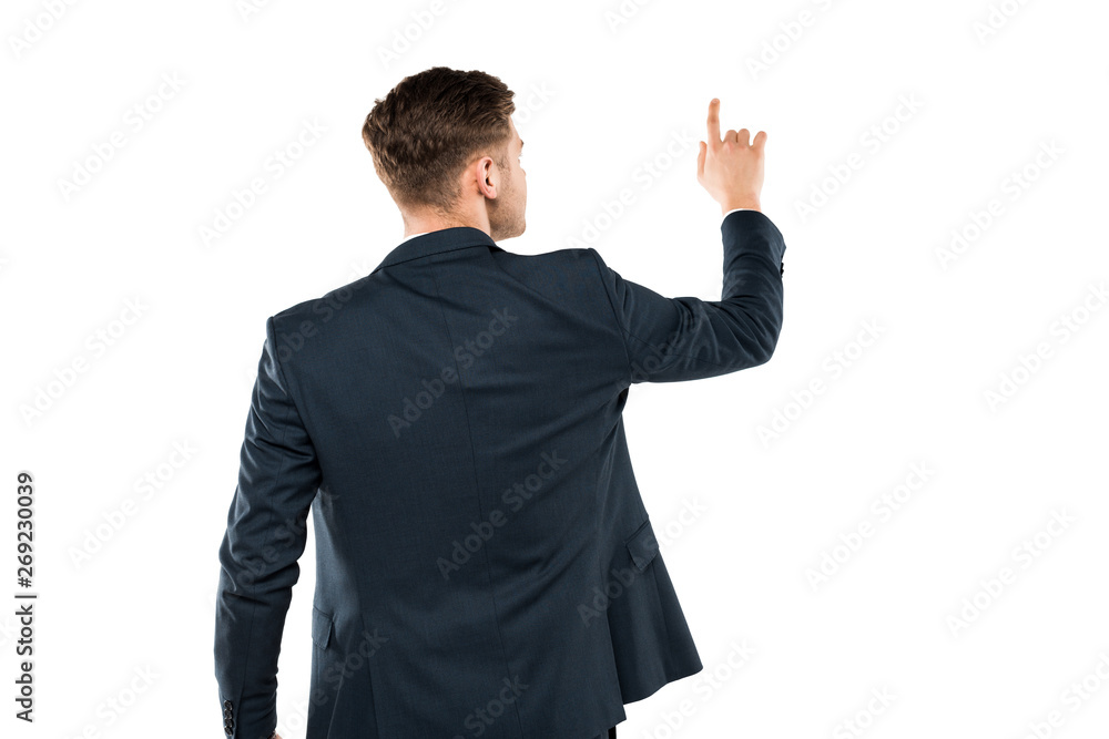 back view of businessman in suit pointing with finger while standing isolated on white back view of businessman in suit pointing with finger while standing isolated on white