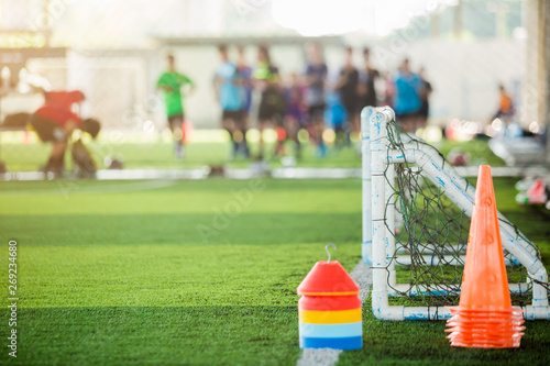 multi color of marker cones and mini goal on green artificial turf for soccer training equipment