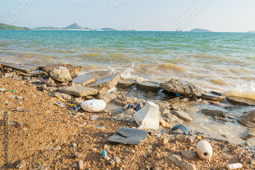 Fototapeta Naklejka Na Ścianę i Meble -  Electronic waste and foam become garbage on the beaches and birty sea water near the pier is a problem and pollution in Chonburi, Thailand