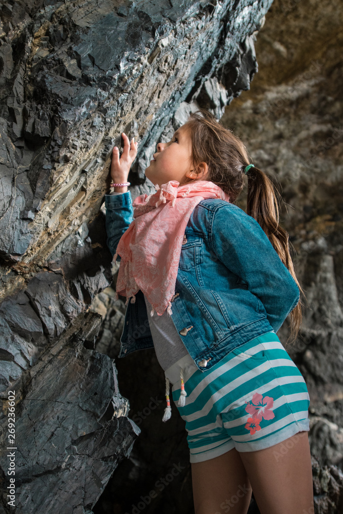  girl on the trip admires the rocks in the caves
