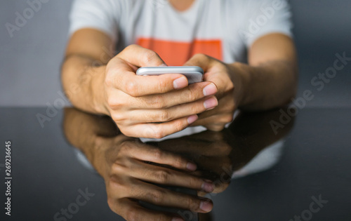 Close up of man using smartphone on table