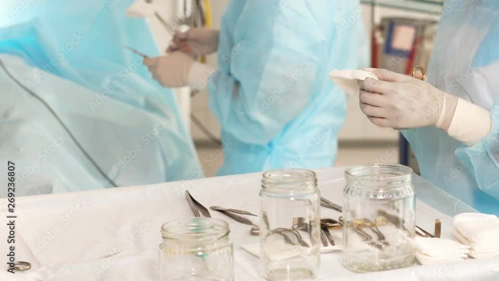 Male assistant preparing medical tools for performing operation. Emergency help concept. Male assistant preparing medical tools for performing operation. Emergency help concept.