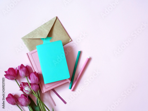 Notebook, diary with tulips on a pink background, top view, women's business concept © Guzel