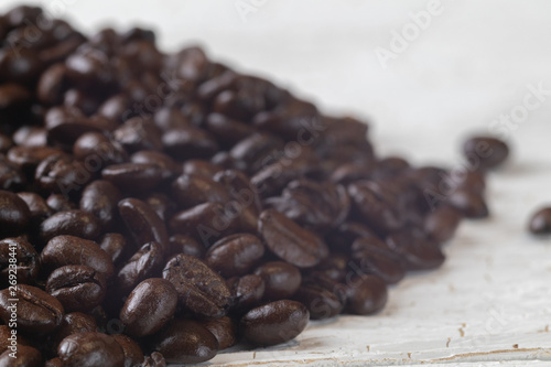 Fototapeta Naklejka Na Ścianę i Meble -  close up of pile roast coffee beans on wooden board