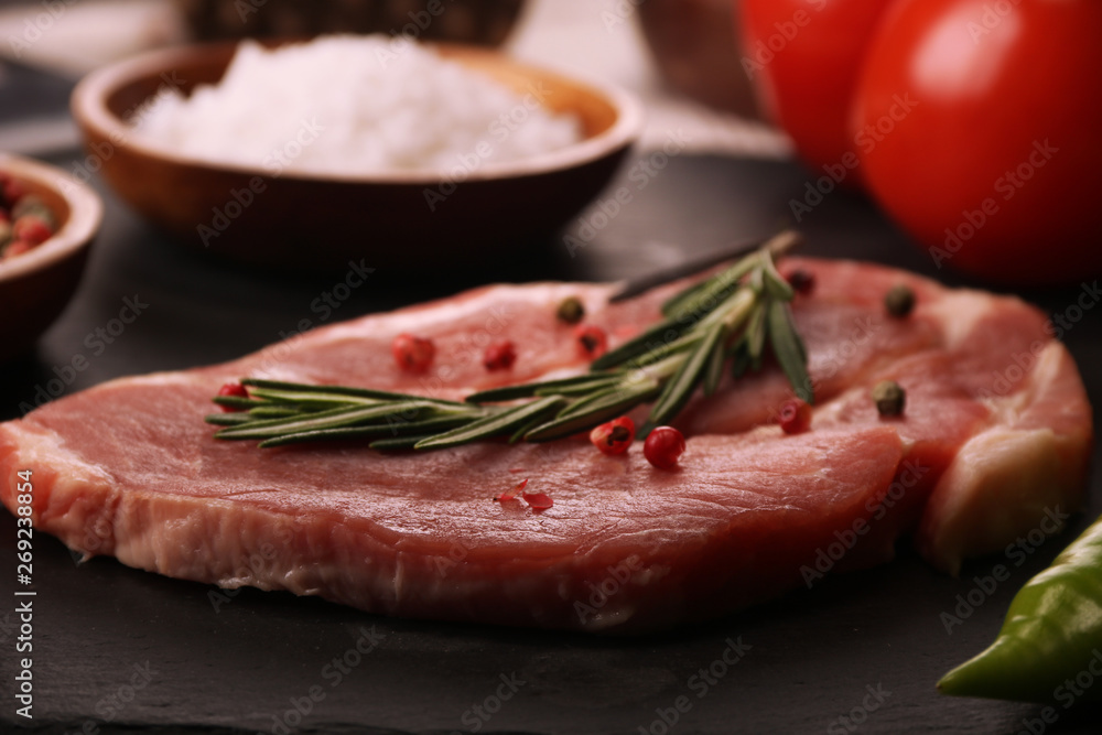Raw pork meat steak with vegetables, peppers, tomato, salt, rosemary and spices cooking over stone table. Top view. Raw pork meat steak with vegetables, peppers, tomato, salt, rosemary and spices cooking over stone table. Top view.