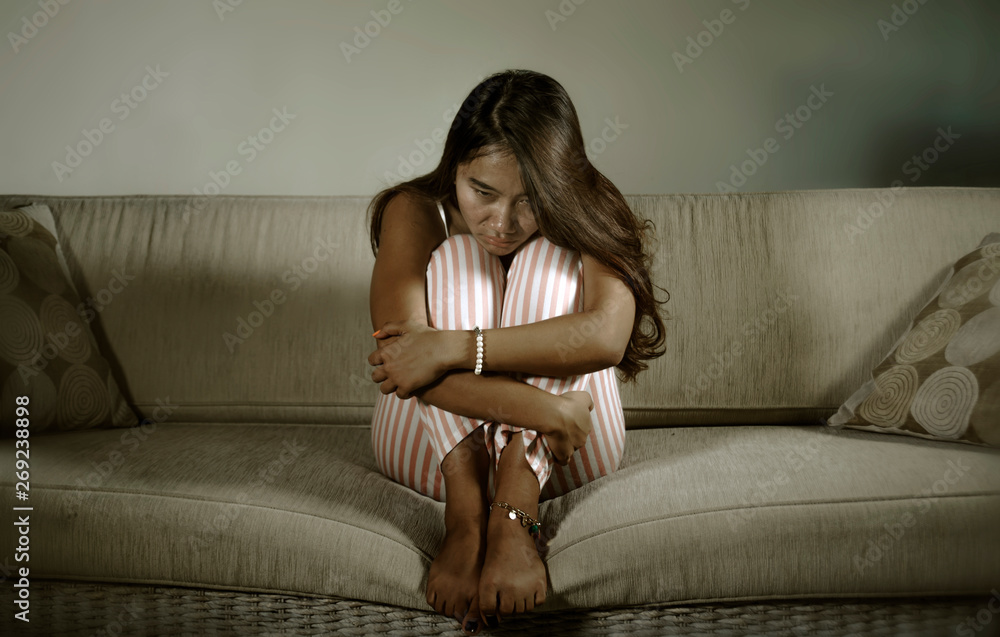 young sad and depressed Asian Indonesian woman sitting at home couch crying frustrated and upset suffering stress and depression after breakup young sad and depressed Asian Indonesian woman sitting at home couch crying frustrated and upset suffering stress and depression after breakup
