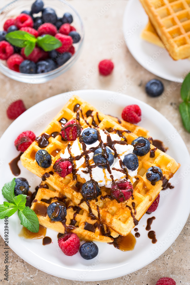 Fresh homemade waffles with blueberries and raspberries Fresh homemade waffles with blueberries and raspberries