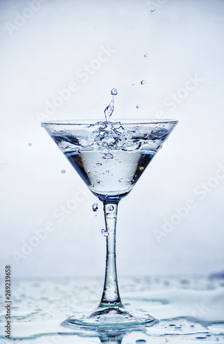 Martini glass with frozen splashing drops of drink