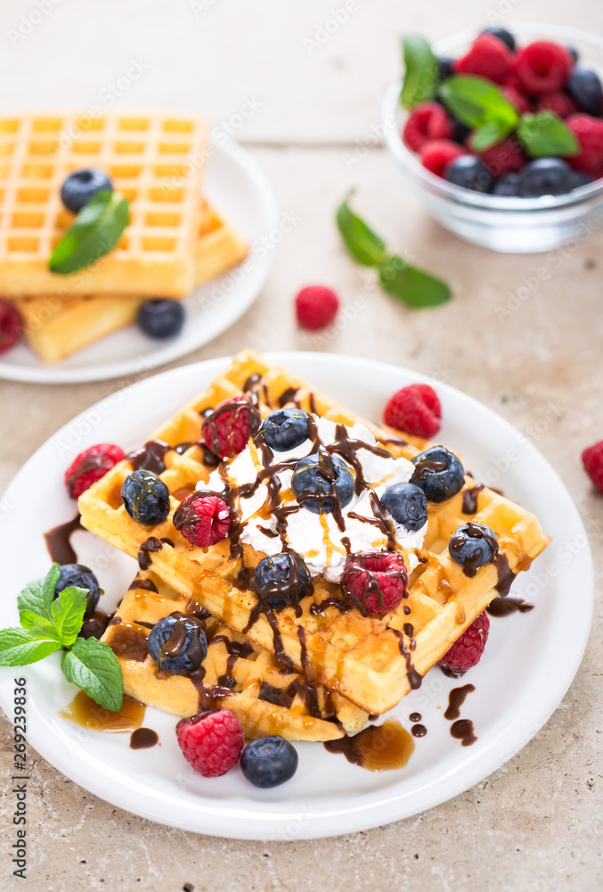 Fresh homemade waffles with blueberries and raspberries Fresh homemade waffles with blueberries and raspberries