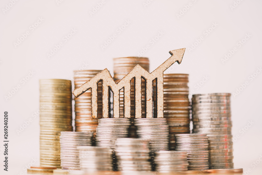 Fotografia Coins stacking and wooden blocks arrow