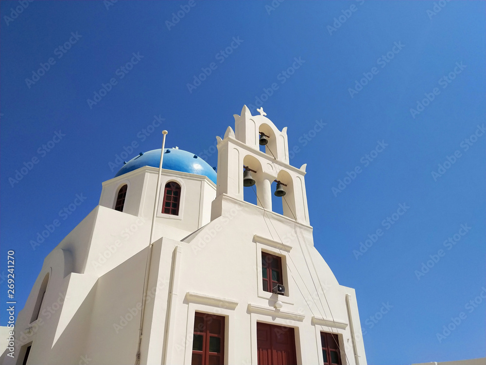White church on blue background. Oia, Santorini, Greece