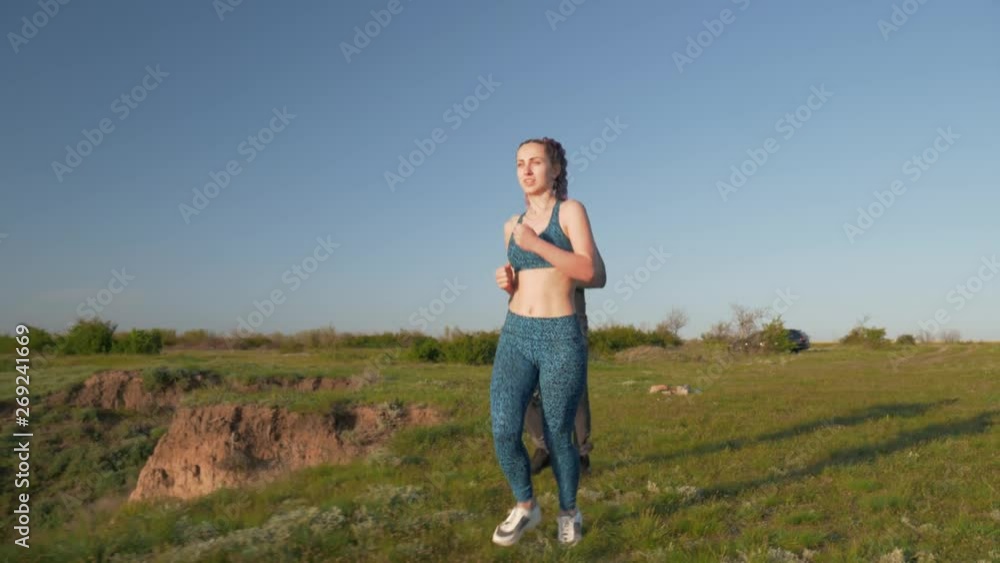 healthy lifestyle, sports family run around on nature on green grass against blue clear sky healthy lifestyle, sports family run around on nature on green grass against blue clear sky