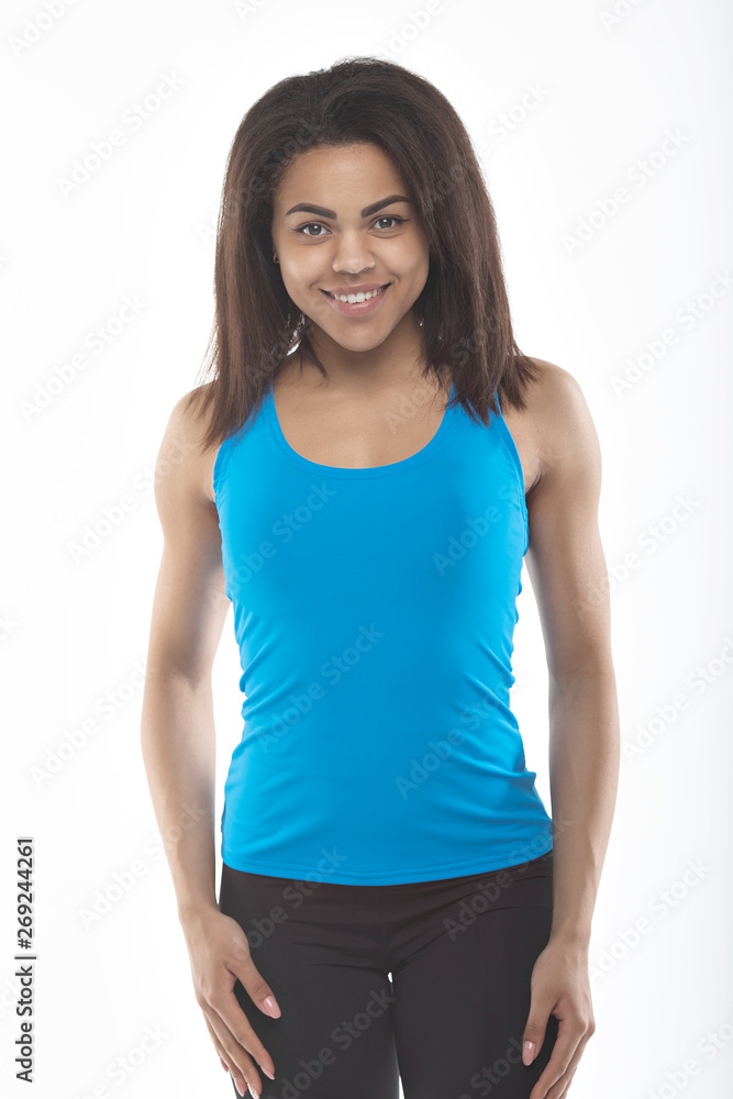 Sport and yoga lifestyle concept. Young fit pretty black woman dressed in sport clothes poses against white Sport and yoga lifestyle concept. Young fit pretty black woman dressed in sport clothes poses against white