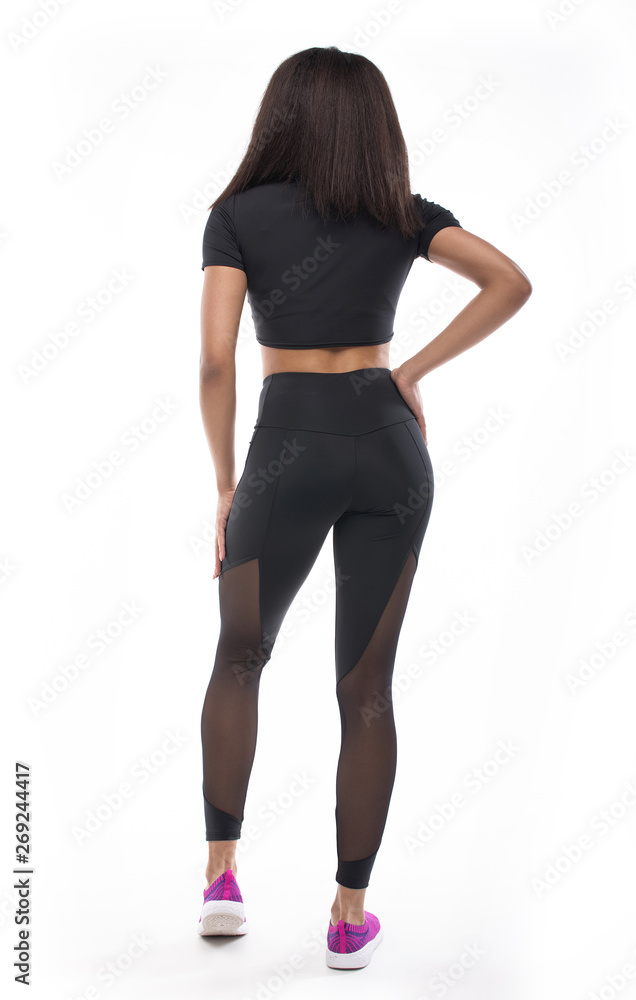 back view of young black woman in sportswear on white background. 