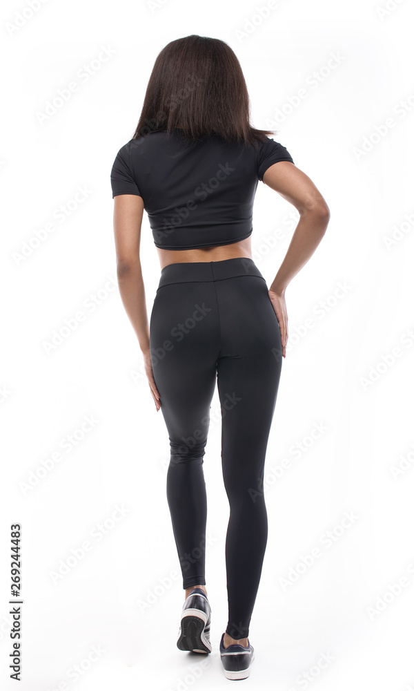 back view of young black woman in sportswear on white background. back view of young black woman in sportswear on white background.