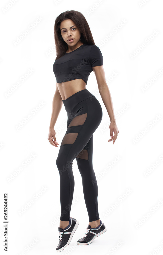 Full length portrait of a young fitness woman in sportswear posing a isolated over white background Full length portrait of a young fitness woman in sportswear posing a isolated over white background