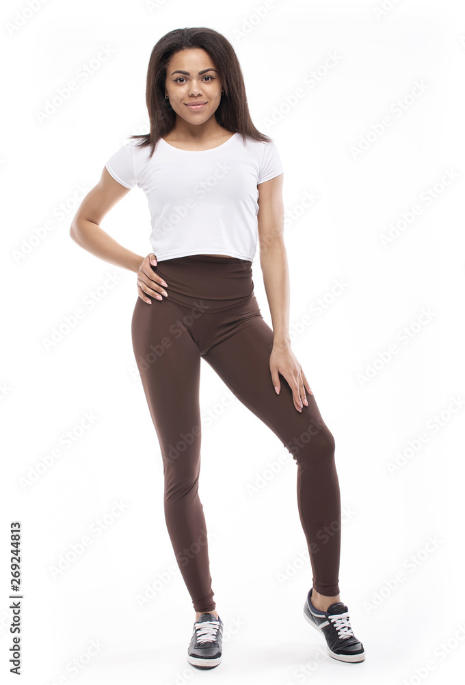 fitness woman in sport style standing against white background. fitness woman in sport style standing against white background.