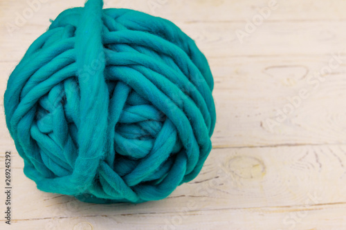 Merino wool yarn ball on white wooden background