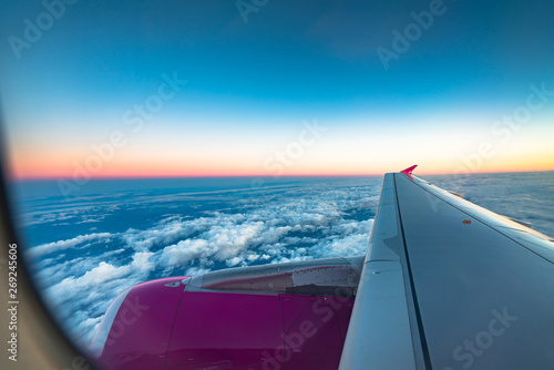 Sunrise view from the window of an airplane flying in the clouds, top view clouds like the sea of clouds sky background, Aerial view background, Yamanashi, Japan © yaophotograph