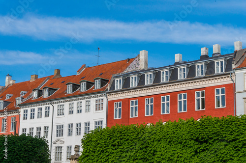 Scenic summer view of the ancient classic colorful houses with blue sky in Copenhagen, Denmark © Gabriel Teleptean