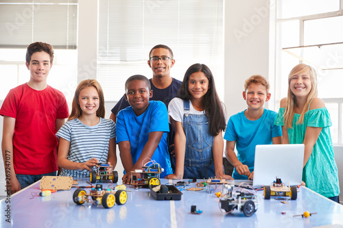 Portrait Of Students With Teacher Building Robot Vehicle In After School Computer Coding Class photo