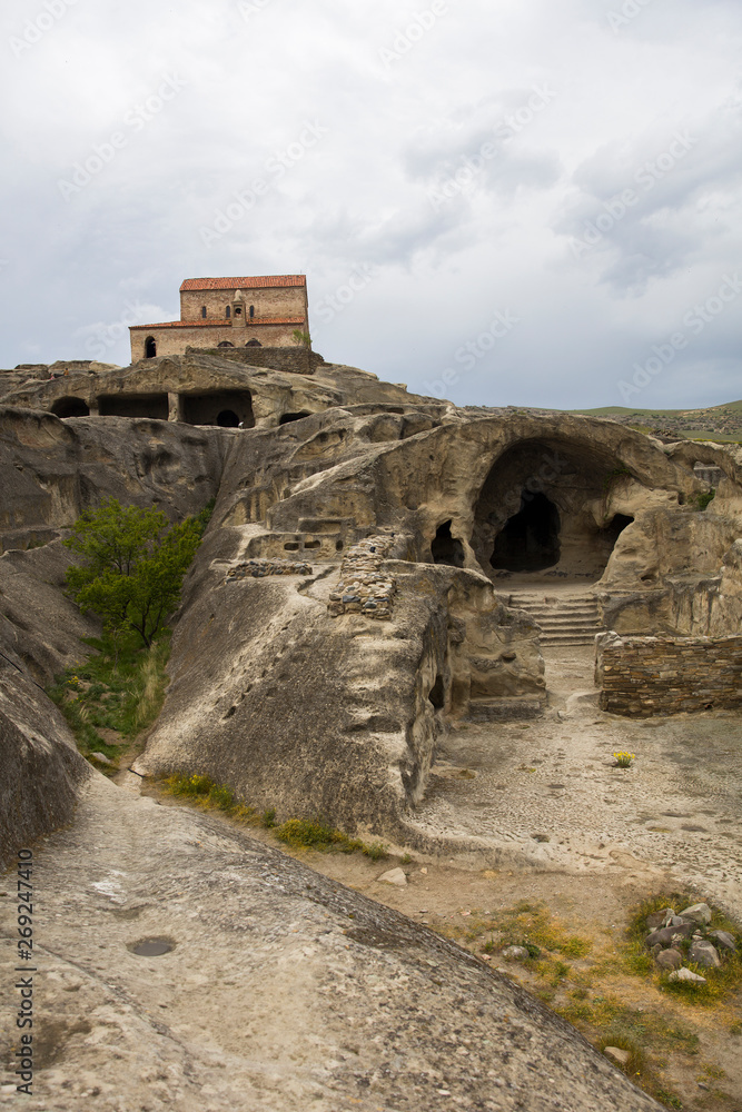 Cave city of Uplistsikhe with the basilica church in the background, in Georgia