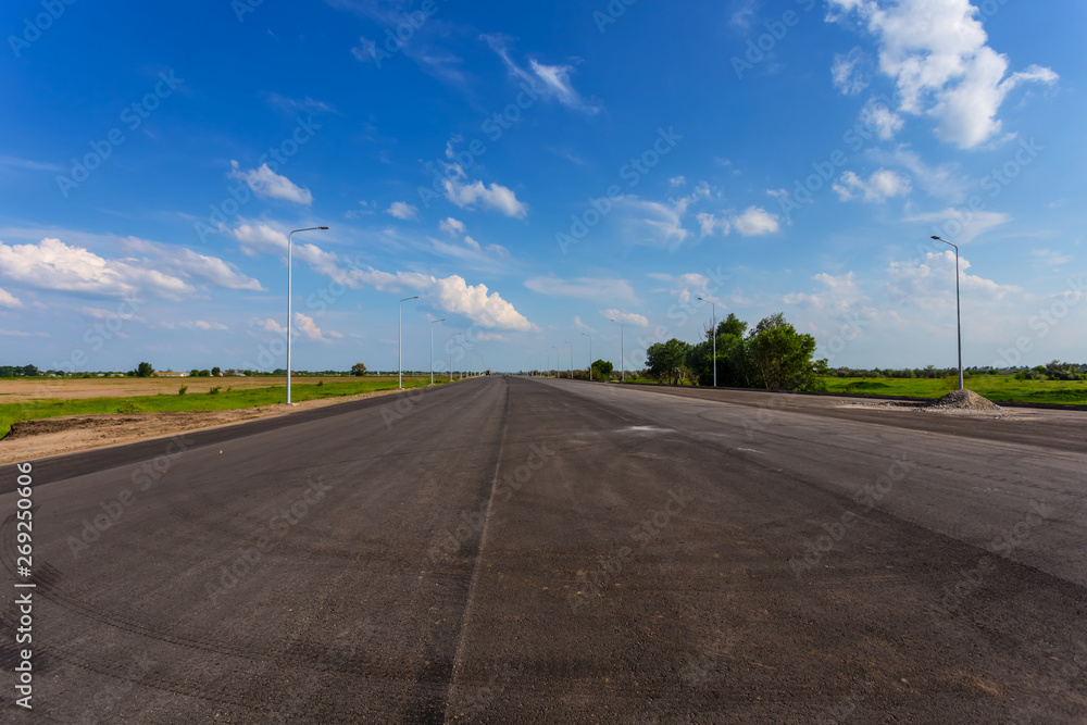 asphalt road building, new pavement and clouds asphalt road building, new pavement and clouds