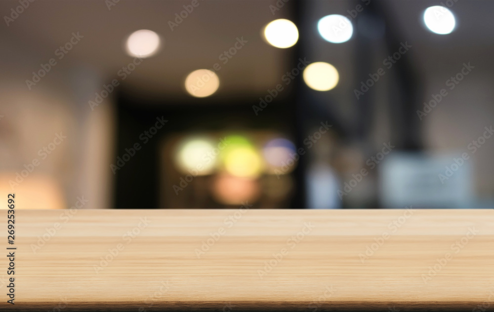 Empty wooden table and blurred background of abstract in front of coffee shop or restaurant for display of product or for montage Empty wooden table and blurred background of abstract in front of coffee shop or restaurant for display of product or for montage