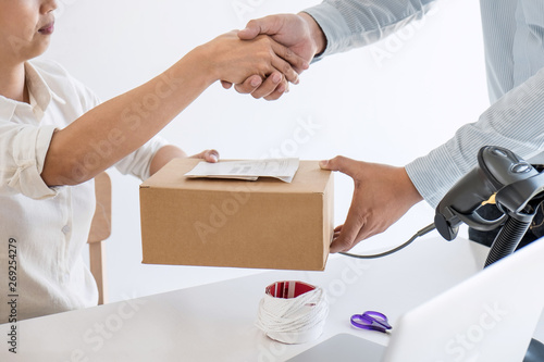 Handshake of Entrepreneur SME to receive order client and working with packaging sort box delivery online market on purchase order and preparing package product, Small business parcel for shipment