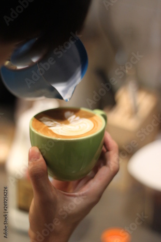 Barista pouring latte art