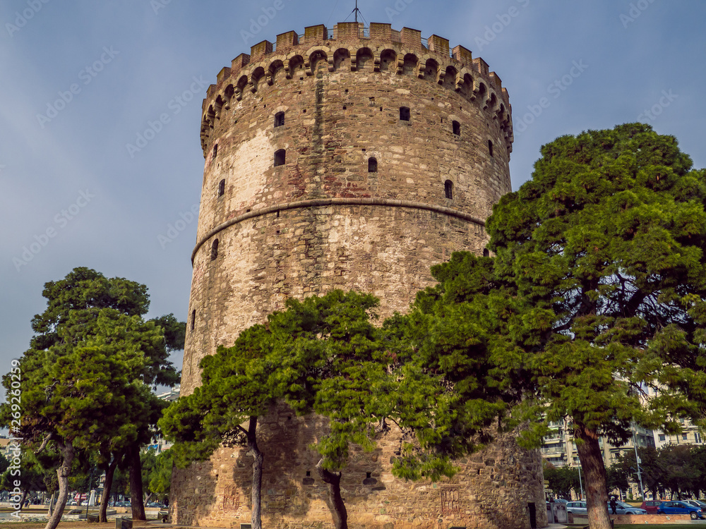 White Tower of Thessaloniki - medieval prison tower, now a museum, surrounded by trees - Thessaloniki, Greece White Tower of Thessaloniki - medieval prison tower, now a museum, surrounded by trees - Thessaloniki, Greece