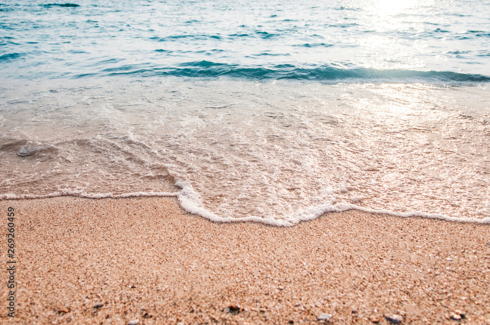 Soft wave of blue ocean on sandy beach