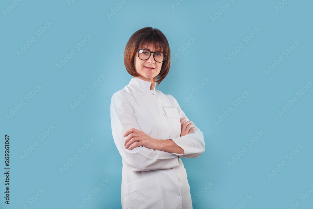 Female doctor standing and smiling with her arms crossed Female doctor standing and smiling with her arms crossed