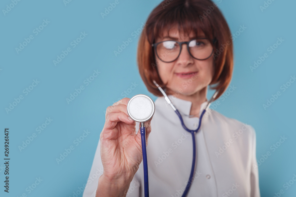 Doctor woman hand holding a stethoscope on blue background Doctor woman hand holding a stethoscope on blue background