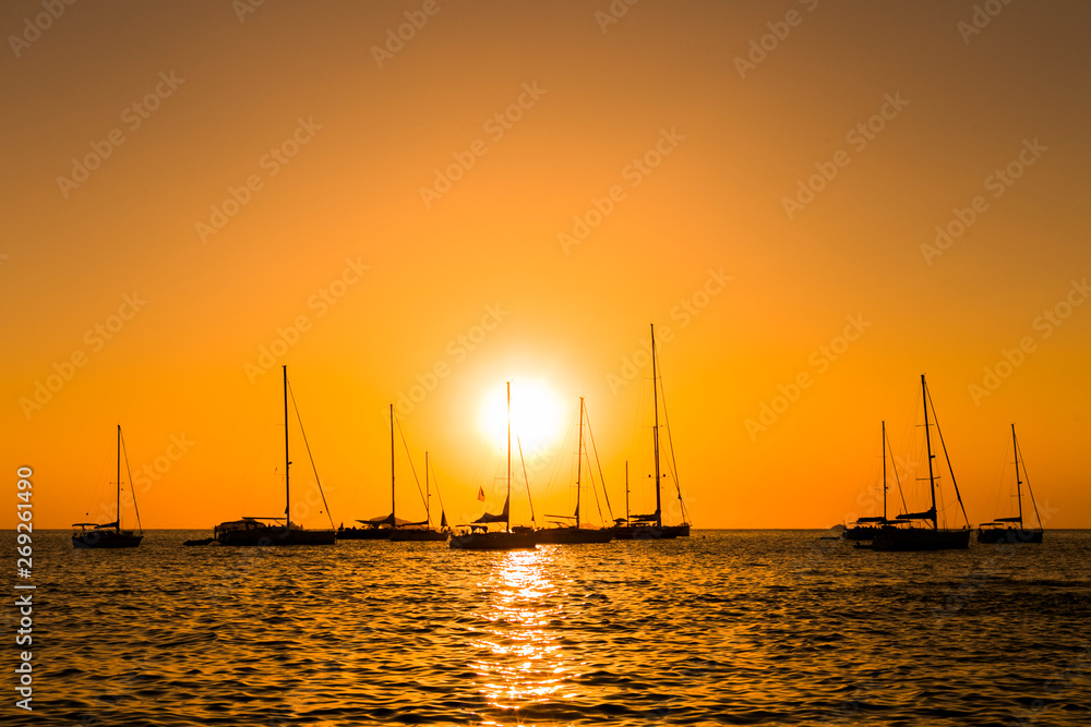 silhouette of boats at sunset in the ocean. Relax and vacation concept silhouette of boats at sunset in the ocean. Relax and vacation concept