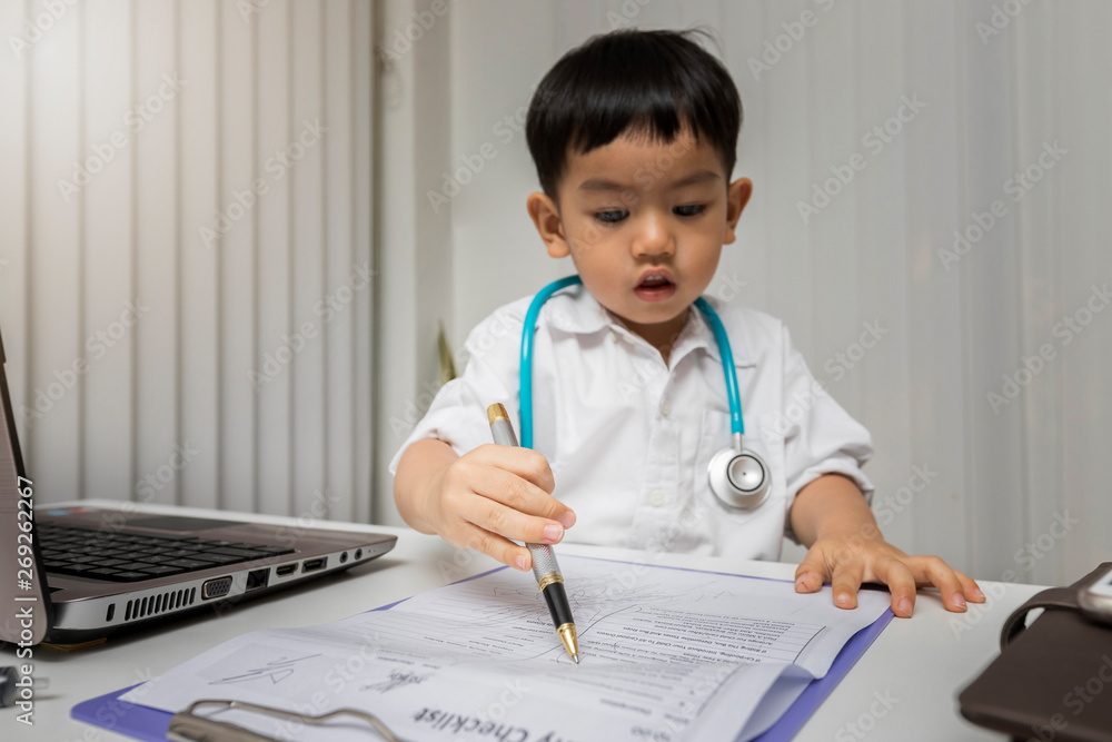 Childhood dream and Careers in children's dreams concept. Little boy with a stethoscope working in medicine on desk. Childhood dream and Careers in children's dreams concept. Little boy with a stethoscope working in medicine on desk.