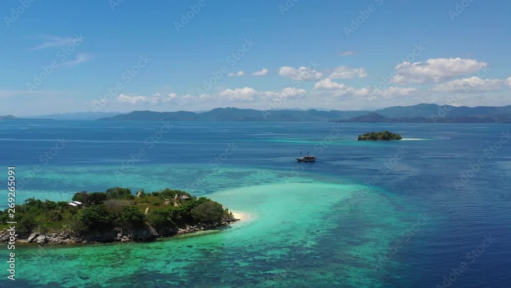 A small ship drifts between islands in Komodo National Park, Indonesia. This area of the Lesser Sunda Islands is known for its high marine biodiversity. A small ship drifts between islands in Komodo National Park, Indonesia. This area of the Lesser Sunda Islands is known for its high marine biodiversity.