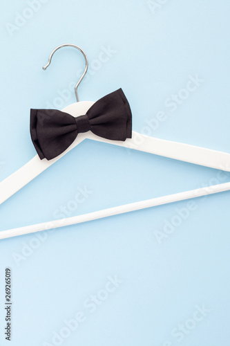 White wooden hangers on blue background