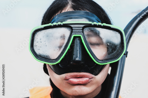 Close-up Asian woman wearing a black half-face snorkels