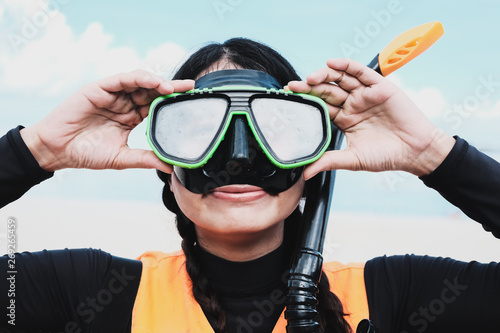 Close-up Asian woman wearing a black half-face snorkels