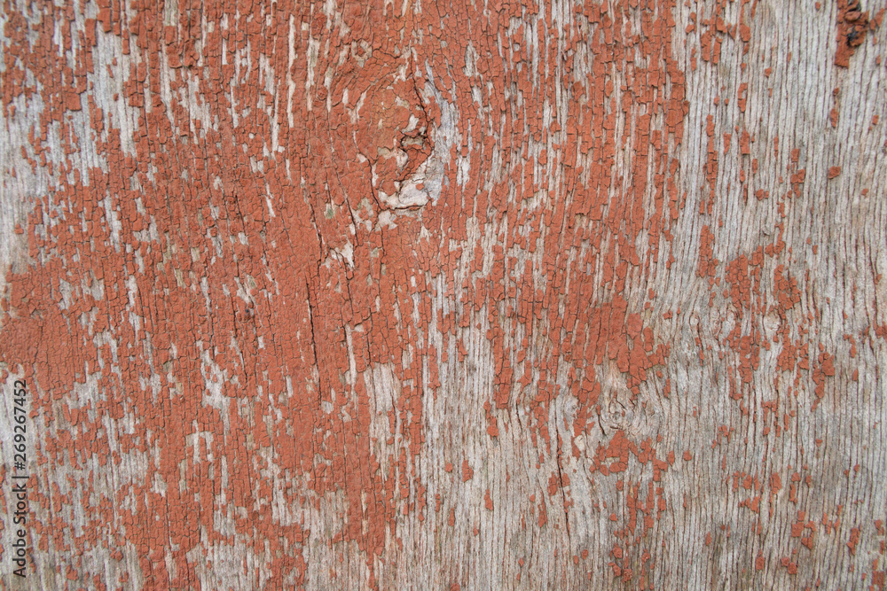 wooden wall with cracked red paint