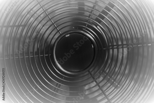 Black and white picture of metal electric fan , air conditioner with moving blades and vignette frame.