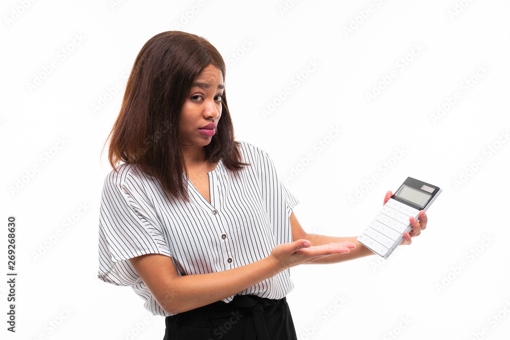 charming dark-skinned young girl explain smth with help of calculator isolated on background charming dark-skinned young girl explain smth with help of calculator isolated on background