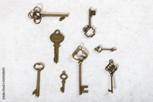 Decorative keys of different sizes and styles on grey background © manuta