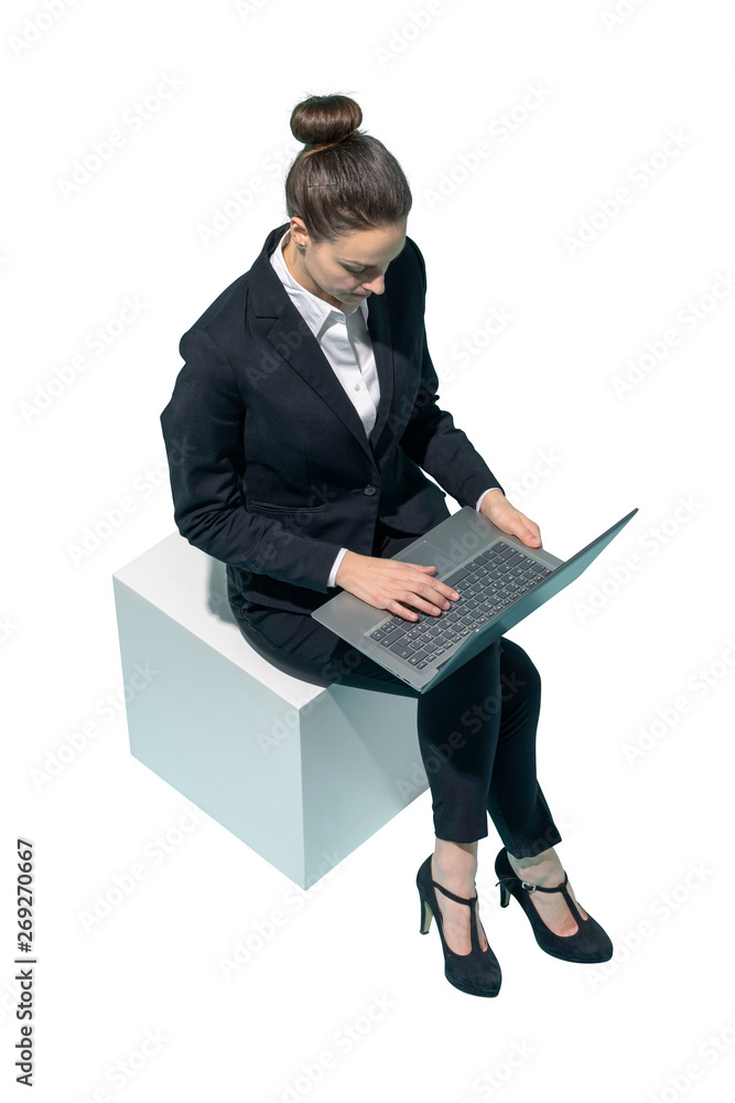 Corporate businesswoman sitting and using a laptop Corporate businesswoman sitting and using a laptop