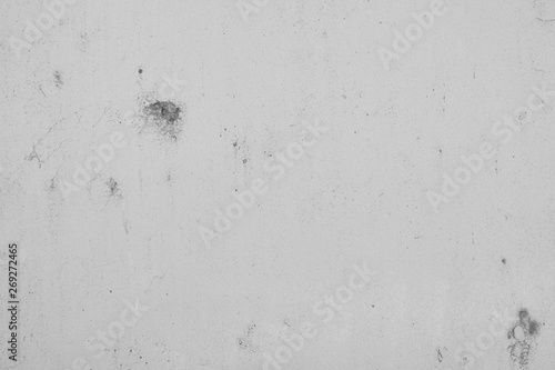 Grauer Hintergrund, Betonwand in Grau im Industrial Style. Grau Textur mit rissigen und rauen Strukturen und Beschädigungen.