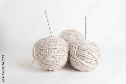tree beige kniting balls of wool on white background